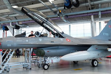 　６月２７日、  ウクライナがおよそ２年前から西側諸国に供与を求めていたＦ１６戦闘機の第１弾が来月、ようやく到着する。　写真は２０２３年８月、デンマーク南部ボエンスの空軍基地で、F１６戦闘機の操縦席に座るウクライナのゼレンスキー大統領（左）とデンマークのフレデリクセン首相（２０２４年　ロイター/Ritzau Scanpix/Mads Claus Rasmussen)