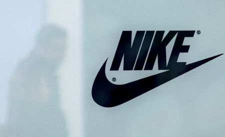 FILE PHOTO: A customer is reflected in a shop window decorated with Nike store logo at the outlet village Belaya Dacha outside Moscow, Russia, April 23, 2016.  REUTERS/Grigory Dukor/File Photo