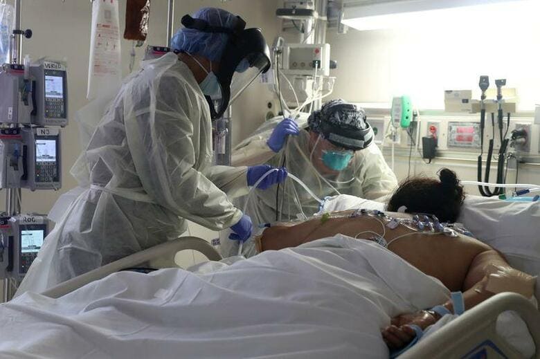 ロイターの集計によると、世界の新型コロナウイルス感染による死者が5日、70万人を突破した。写真はカリフォルニア州のICUでコロナ感染症患者に対応する医療従事者。5月撮影(2020年　ロイター/Lucy Nicholson)