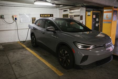 　６月２５日、エネルギー情報会社ライスタッド・エナジーは、データセンターと電気自動車（ＥＶ）向けの電力需要が２０３０年までに米国全体の電力需要を約３００テラワット時（ＴＷｈ）押し上げるとの見通しを示した。写真は充電するＥＶ。米メリーランド州 で昨年３月撮影（２０２４　ロイター／Bing Guan）