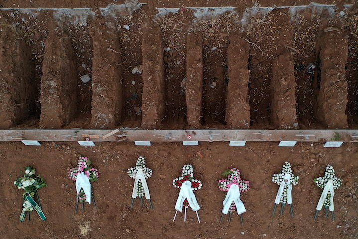 新型コロナウイルス感染症で死んだ人のために作られた急ごしらえの墓地と花輪（2020年12月、ギリシャのテッサロニキ）　Alexandros Avramidis-REUTERS
