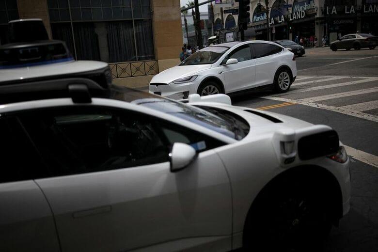 ウェイモの自動運転車とテスラ車、米カリフォルニア州ロサンゼルス2025年5月撮影　REUTERS/Daniel Cole