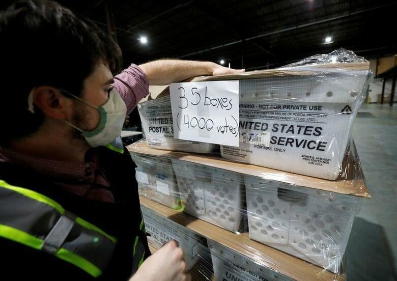 トランプ米大統領と共和党の一部政治家はこれまで再三、証拠もなく、11月大統領選で郵便投票が急増すれば、大量の不正に結び付くと断言している。写真は4日、ノースカロライナ州ローリーで、郵送用の投票用紙を整理する選挙管理委員会関係者(2020年　ロイター/Jonathan Drake)