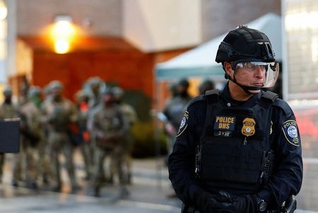 写真は移民収容施設を警備する警察官。10月26日、米オレゴン州ポートランドで撮影。REUTERS/John Rudoff