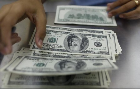 　１月１７日、正午のドル／円は、前日東京午後５時時点に比べ、わずかにドル安／円高の１１４．０１／０３円。 写真はミャンマーのヤンゴンで２０１３年５月撮影（２０１７年　ロイター／Soe Zeya Tun）
